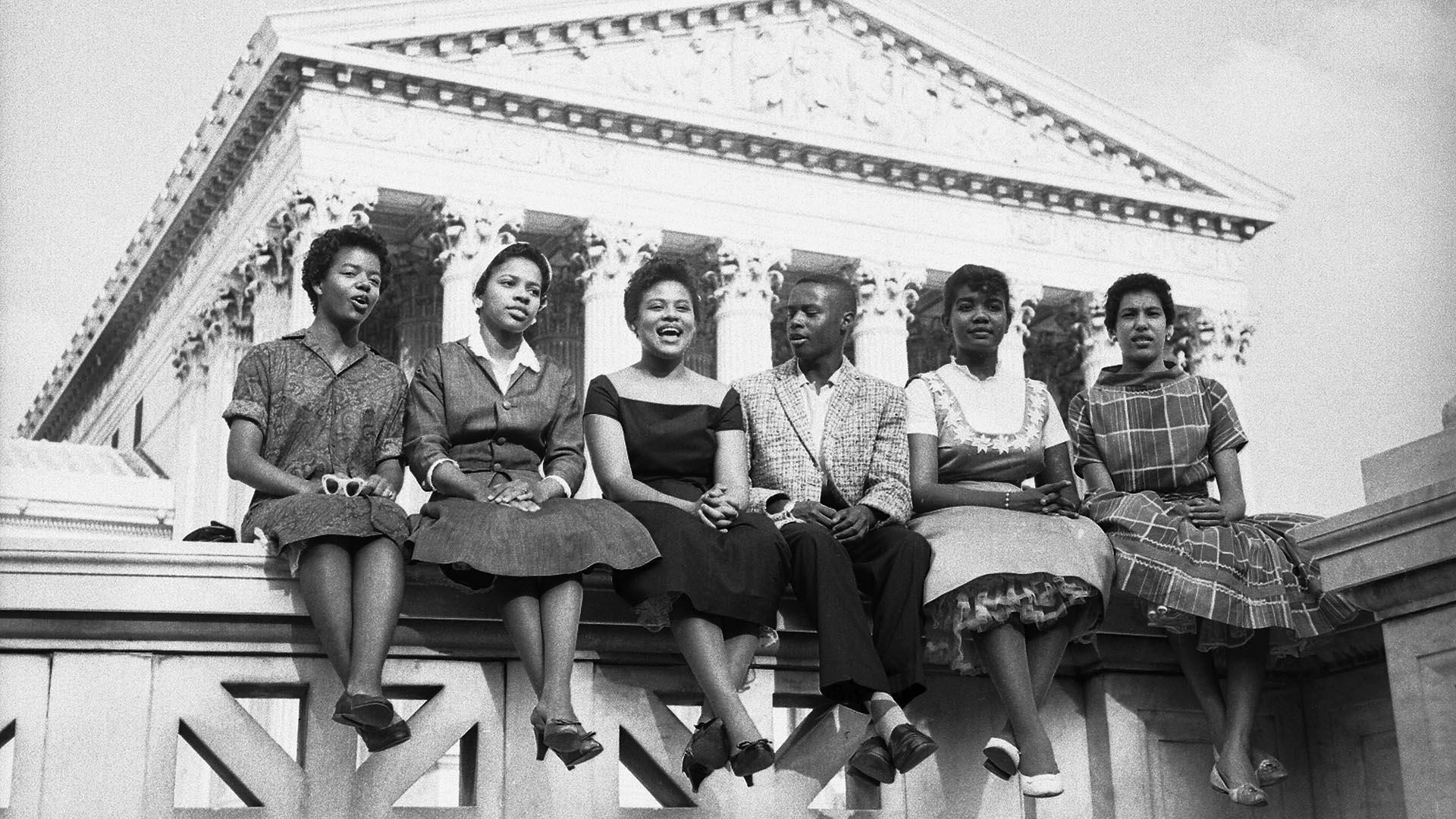 Six Black children who attended Little Rock's Central High School sit outside the Supreme Court in this 1958 photo. From left to right: Carlotta Walls, 15, Melva Patillo, 16, Jefferson Thomas, 15, Minnie Jean Brown, 16, Gloria Ray, 15, and Elizabeth Edkford, 16. Photo: Getty Images